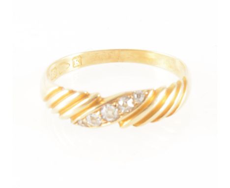 A diamond set 18 carat yellow gold ring, the five old cut diamonds graduating in size set on the diagonal to an 18 carat yell