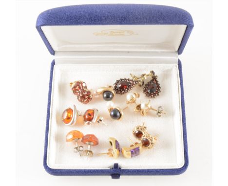 Eight pairs of gold and silver earrings, all for pierced ears with post and butterflies, amber, cultured pearl, garnet pear s