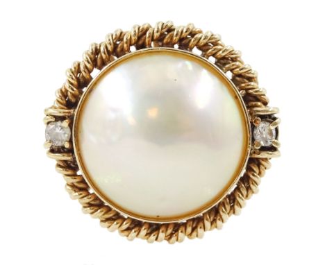 Gold three stone mabe pearl and round brilliant cut diamond ring, within a rope twist frameCondition Report:Approx 4.5gm, siz