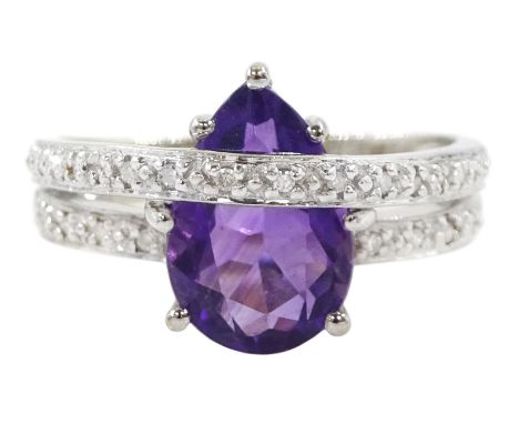 18ct gold amethyst and diamond ring, pear cut amethyst to a diamond set crossover band, stamped 750Condition Report:Approx 5.