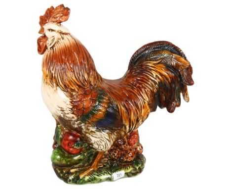 A large ceramic rooster, with crackle glaze finish, on a bed of vegetables and fruits, H48cm 