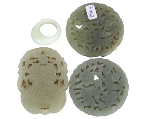 A group of 4 jade Chinese carvings, including a jade ring, and 3 jade pendants/medallions with various floral and animal carv