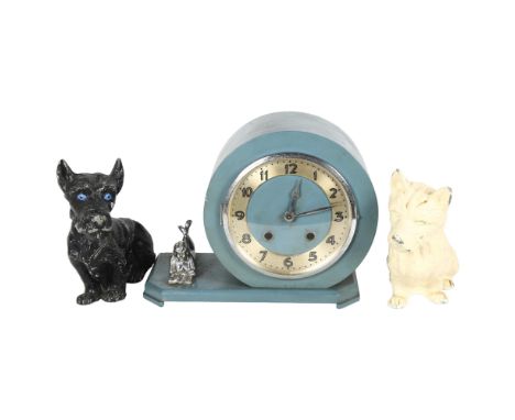 An early 20th century painted mantel clock, with 8-day movement, shaped canted base with figure reading a book, H22cm, comple