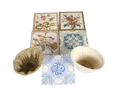 A quantity of Antique ceramic tiles with varying designs, and 2 Antique Victorian jelly moulds with fruit and floral moulding