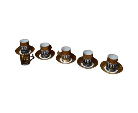 A set of 5 Limoges coffee cans and saucers, in pierced silver holders, and an extra holder 
