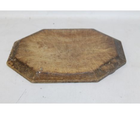 A ROBERT THOMPSON 'MOUSEMAN' WOODEN HEXAGONAL BREAD BOARD, with carved mouse on edgeConditionReport:Very worn and scratched