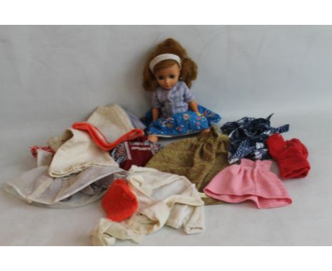 AN ENGLISH MADE VINTAGE CHILTERN DOLL, with ginger hair, blue eyes, moving eyelids, together with eight outfits 