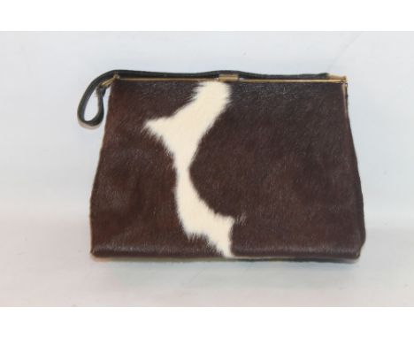 A VINTAGE COW HIDE HANDBAG, with gilt metal fittings and satin lined interior
