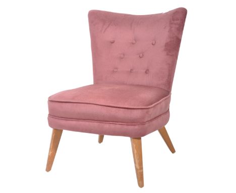 A retro vintage 1950's German cocktail chair / bedroom chair in the manner of Howard Keith having a shaped button back with c