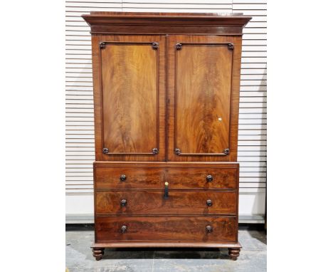 19th century mahogany caddy top linen press, the two moulded panel doors opening to four pull-out linen slides, over a base w