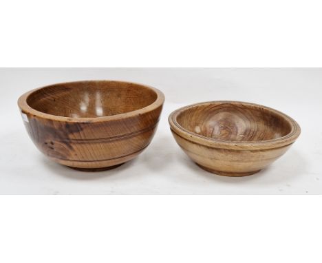 Two treen elm bowls in sizes, each turned, the first 19th/early 20th century (with repair to foot), 30cm diam. the second 26.