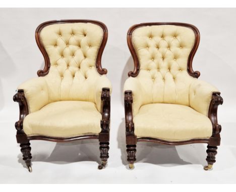 Pair of Victorian salon armchairs with yellow button back upholstery, the mahogany frames with carved scroll backs and arms, 