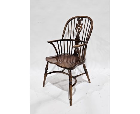 Elm seated and ash Windsor hoop and comb back elbow chair with shaped pierce splat, saddle seat, on turned legs united by a c