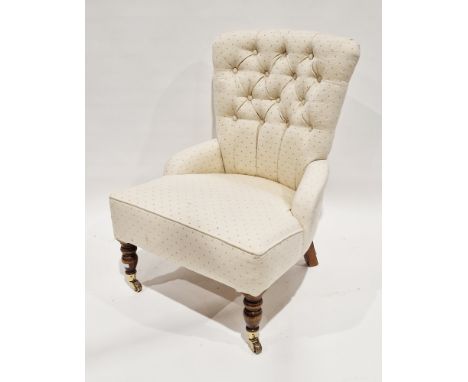 19th century style button-back easy chair, upholstered in a cream fabric, on turned baluster oak front legs terminating in ca