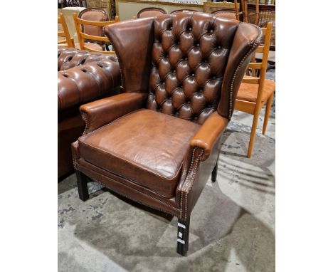 Office reception chesterfield style brown leather wingback armchair, in the 18th century manner with button back and brass st