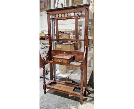 Late 19th / early 20th century mahogany hallstand, the mirrored back with six turned wooden coat hooks above a glove drawer a