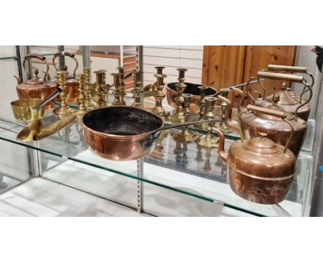 Collection of copper and brass ware dating from 19th century onwards including copper pan with iron handle, three copper kett