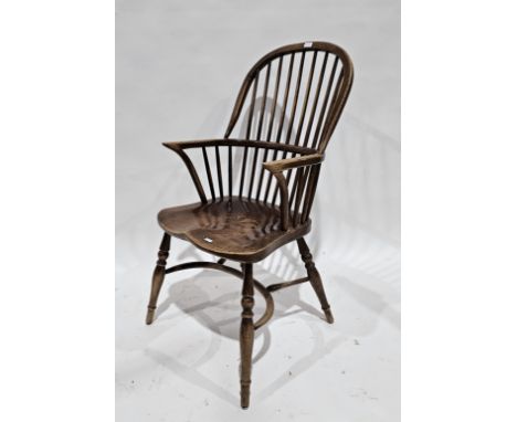 Elm seated and ash Windsor hoop and comb back elbow chair with saddle seat, on turned legs united by a crinoline stretcher, 1