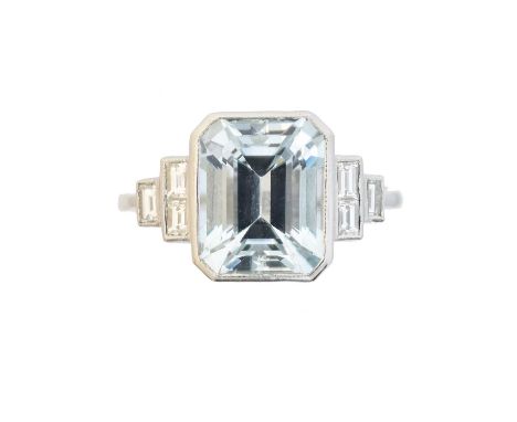 An aquamarine and diamond dress ring, the rectangular shape aquamarine weighing approx. 3cts with baguette cut diamond tapere