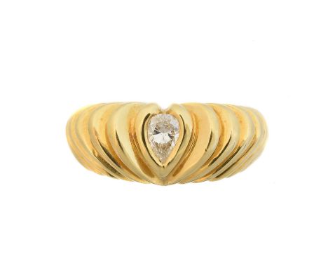 An 18ct gold diamond single stone ring, the pear cut diamond within the grooved band, estimated total diamond weight 0.20ct, 