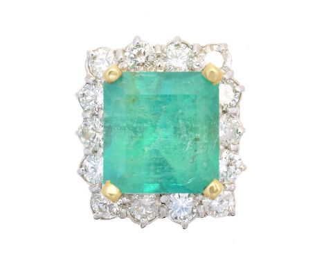 An emerald and diamond cluster ring, the impressive rectangular shape emerald weighing approx. 9.20cts, within a brilliant cu