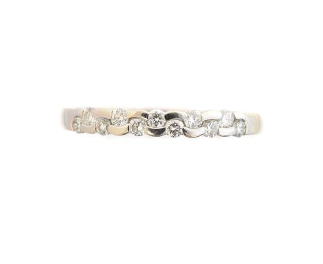 An 18ct gold diamond band ring, the brilliant cut diamond line with curved bar spacers, estimated total diamond weight 0.20ct