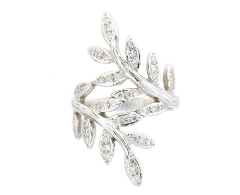 A diamond dress ring, of crossover design with brilliant cut diamond branching terminals, estimated total diamond weight 0.25