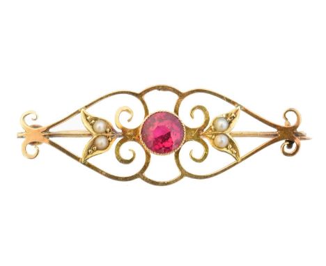 An early 20th century synthetic ruby brooch, the circular synthetic ruby with split pearl duo sides and openwork surround, st