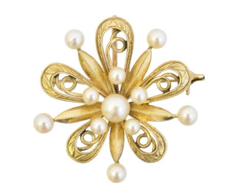 A cultured pearl brooch by Mikimoto, the vari size cultured pearl cluster within an openwork setting, may also be worn as a p