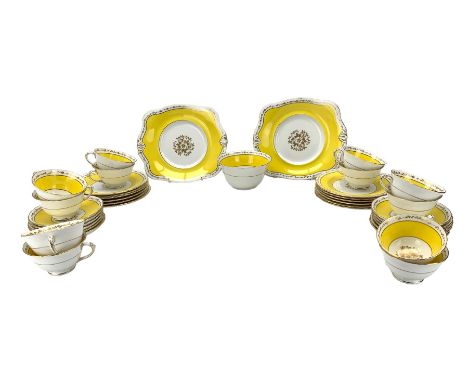 R H Plant Ltd Tuscan china tea set with a floral gilt centre pattern within a yellow border comprising twelve cups and saucer