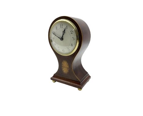 French - Edwardian 8-day balloon clock in a mahogany case, with oval inlay and stringing to the sides and raised on bun feet,