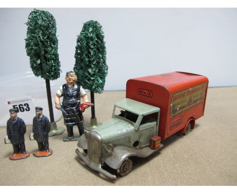 A Pre-War Minic Transport Van, Two Original Hornby trees, Two Hornby station figures, and a lead butcher, all playworn.