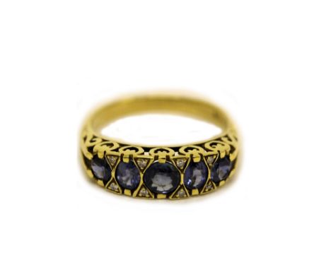 A gold and five-stone sapphire carved half-hoop ring, the oval light blue mixed-cut stones divided by pairs of small brillian