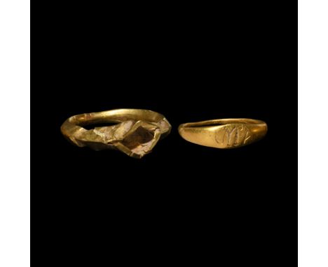 1st-3rd century AD. A pair of gold rings comprising: one hollow-formed with keeled hoop, raised lozenge bezel; a smaller ring