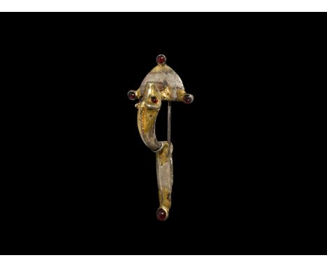 4th-5th century AD. A gilt silver boar bow brooch comprising a D-shaped headplate with three radiating lugs, each set with a 