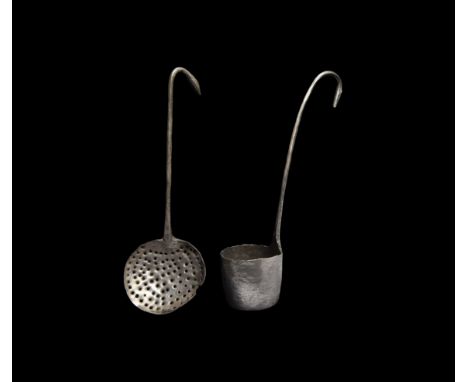 2nd-3rd century AD. A group of silver utensils comprising: wine strainer with pierced shallow circular bowl, the integral han