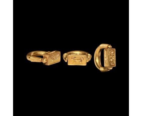 New Kingdom, 1550-1070 BC. &nbsp;A substantial gold finger ring with hollow-formed crescent shank, coiled wire sleeves to the