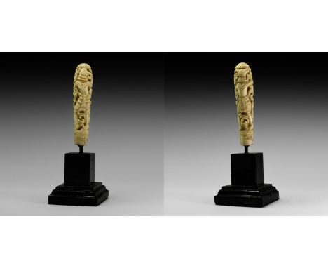 19th-early 20th century AD. A carved ivory handle with addorsed figures of dancing animal-headed deities each wearing a tiere