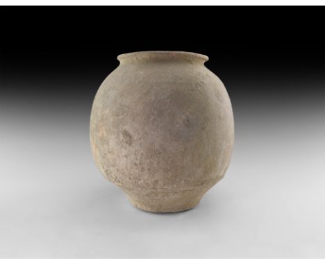 1st-3rd century AD. A substantial squat ceramic storage jar with rolled rim, carinated profile.   3.9 kg, 29cm (11 1/2"). Fro