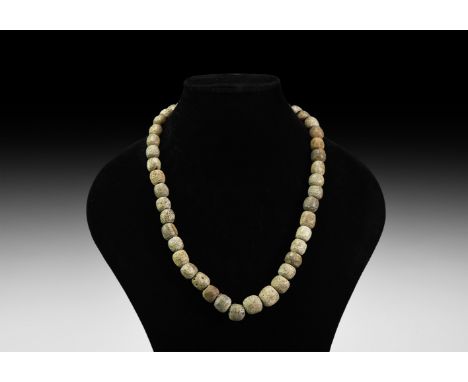 Pleistocene Period, 2.6 million-11,700 years BP. A restrung string of woolly mammoth Mammuthus primigenius oblate bone beads.