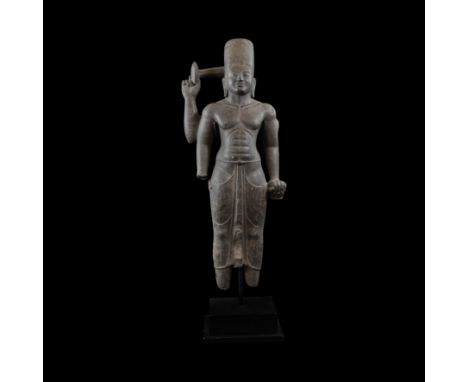 9th-11th century AD. A carved black stone four-armed standing figure of Vishnu with rearmost right hand raised, wearing a sim