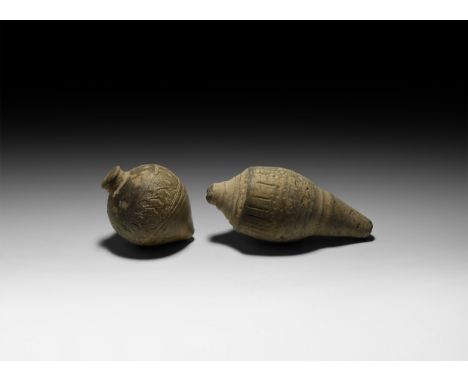 9th-11th century AD. A pair of hollow ceramic vessels, intended to be filled with explosive liquid and a wick, and used as a 