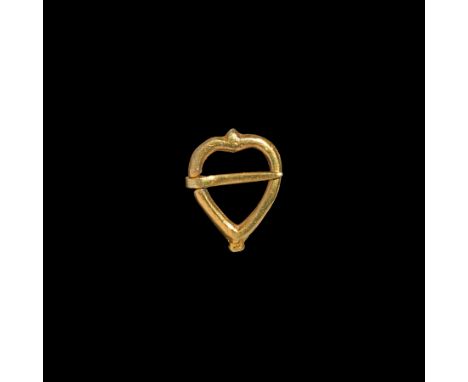 16th-17th century AD. A silver-gilt ring brooch formed as a heart with tapering tongue. 2.05 grams, 22.22mm (3/4"). Property 