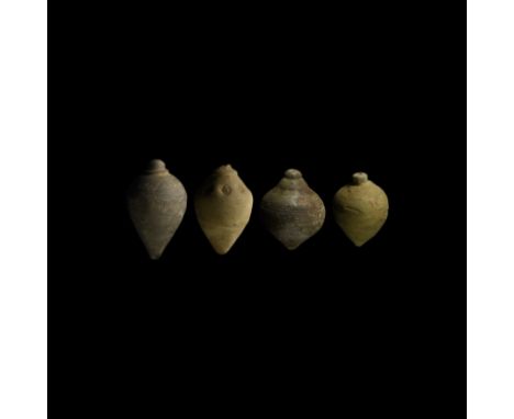 9th-11th century AD. A group of four hollow ceramic vessels each with conical body, intended to be filled with explosive liqu