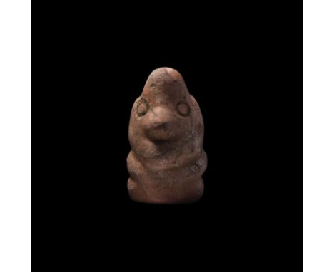 4th century BC. A rhyolite idol with bulbous head and body, low-relief facial features, arms forming a horizontal chevron acr