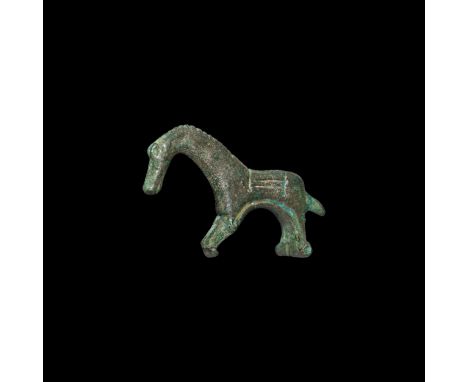 2nd century AD. A bow brooch formed as a standing stylised horse with crossbar to the rear legs, catchplate beneath the front