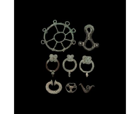 Mainly 1st millennium BC. A mixed bronze group comprising: loop closure with lateral bulbs; c-shaped fastener with disc finia