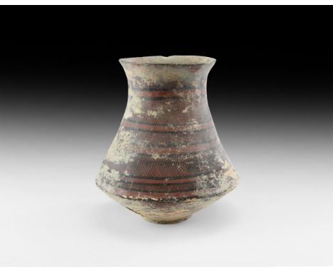 3rd-2nd millennium BC. A ceramic biconvex jar with flared mouth, painted concentric bands to the shoulder.   696 grams, 18.5c