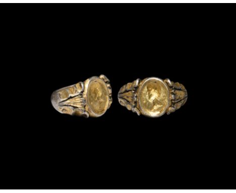 1st century AD. A substantial silver ring with expanding D-shaped hoop, angled shoulders with scalloped edges flanking a flut