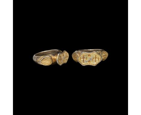 12th century AD. A substantial silver-gilt ring with expanding D-shaped hoop, teardrop-shaped plaques to each shoulder, raise